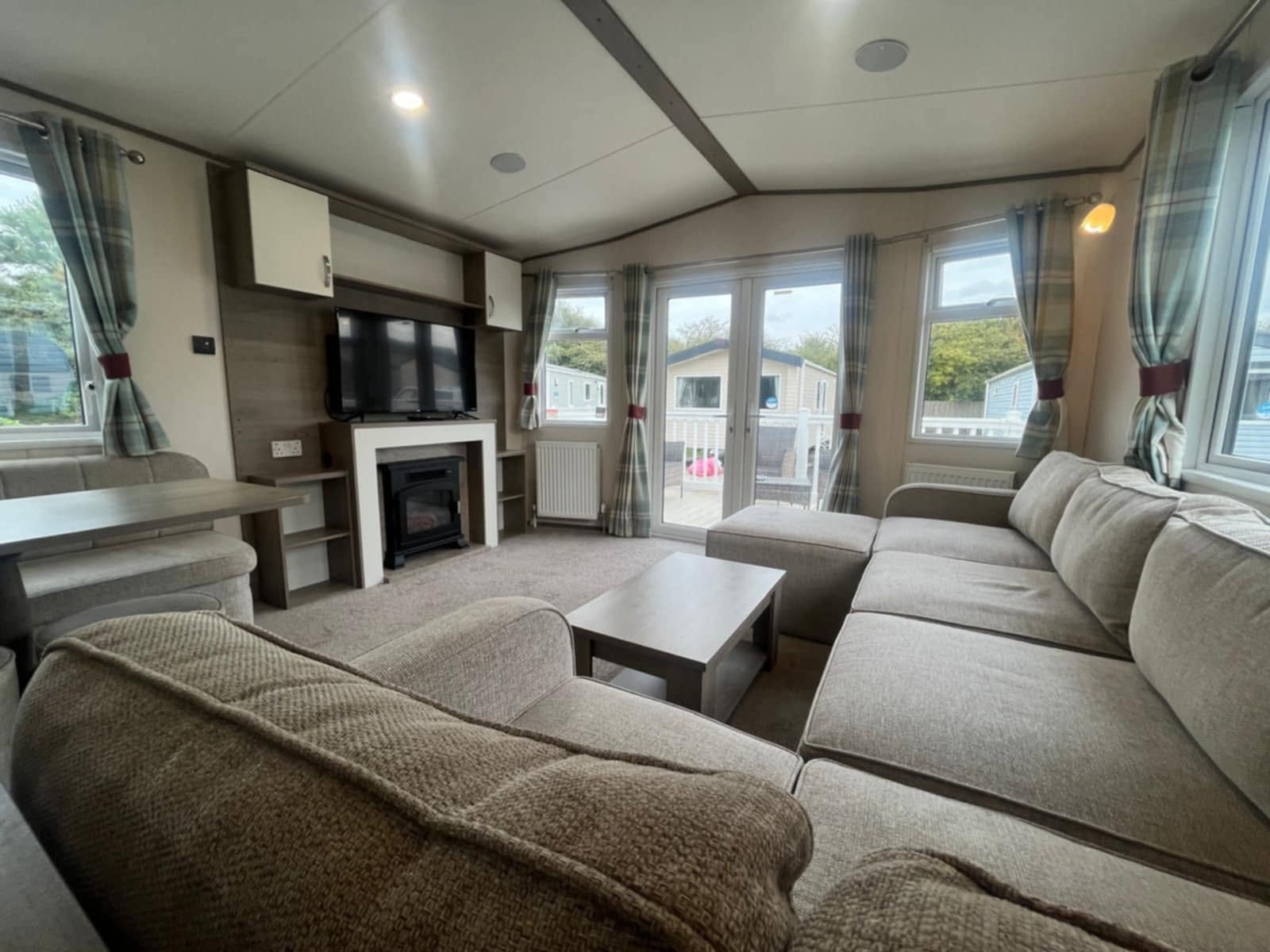 Boundary Road spacious lounge with corner sofa and patio doors