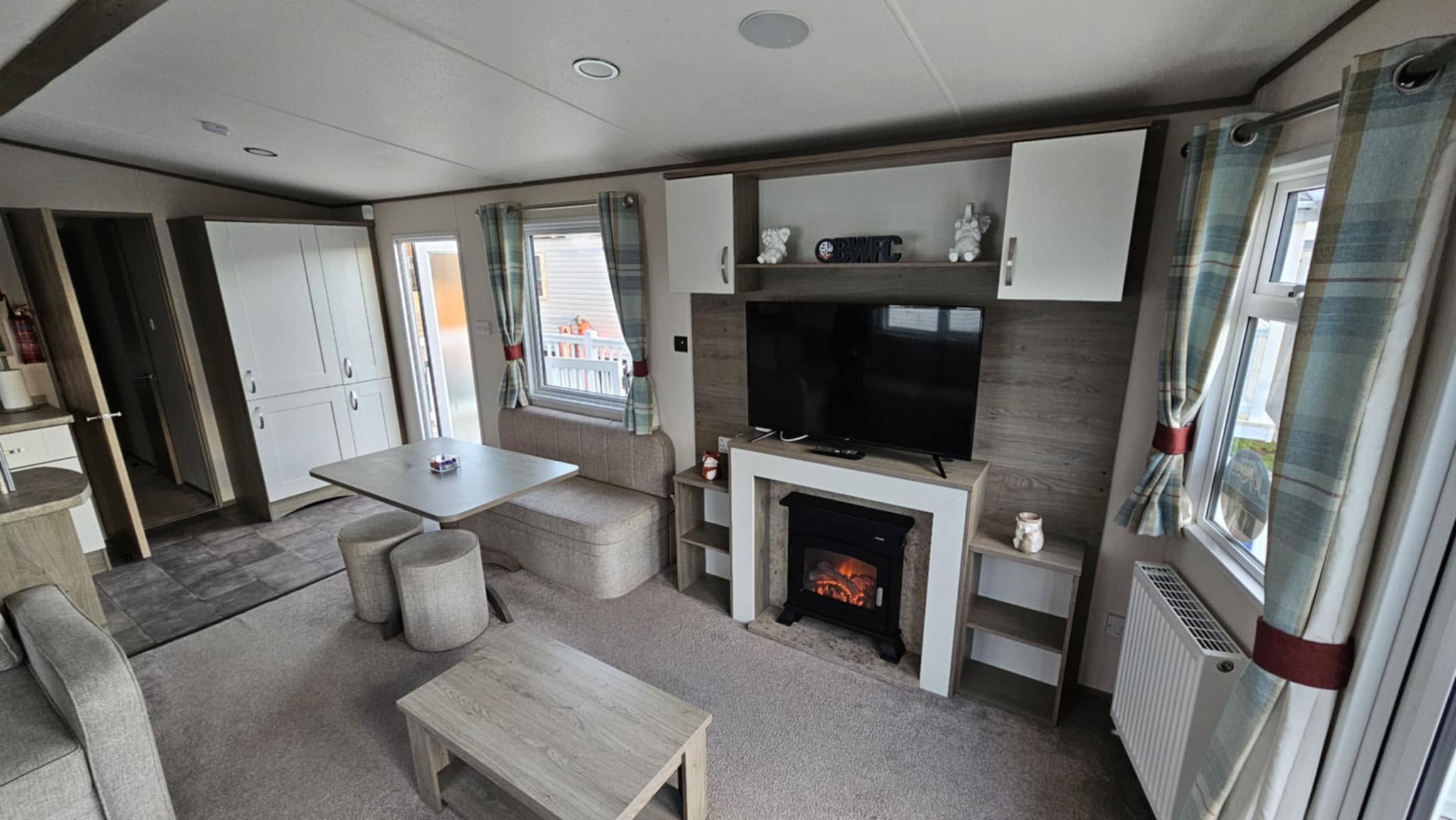 Boundary Road lounge with TV, fireplace and dining area