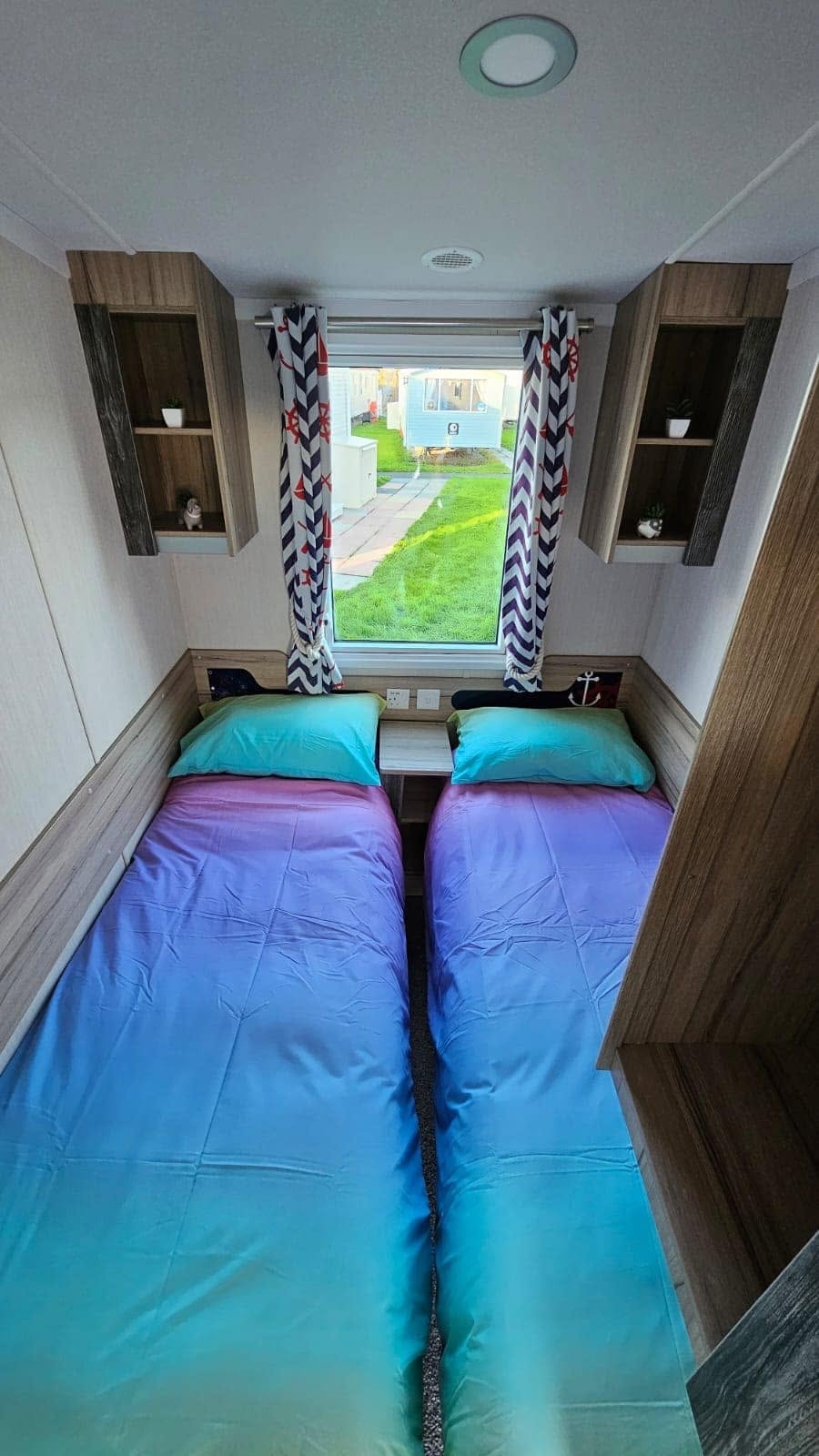 Rossall Court twin bedroom with purple and teal bedding